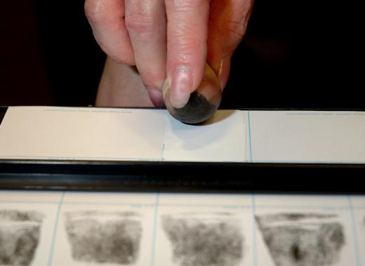 Person having fingerprints taken for an FBI background check.